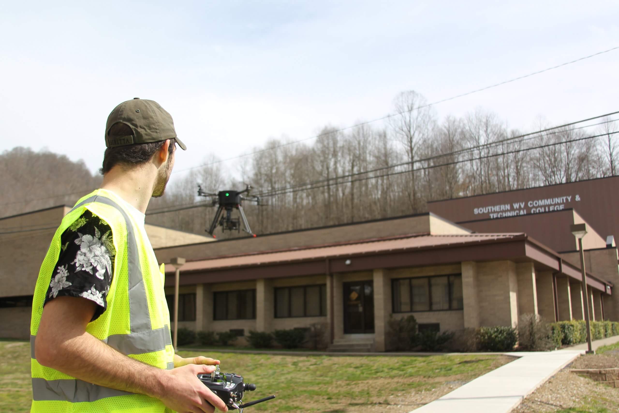 student flying drone