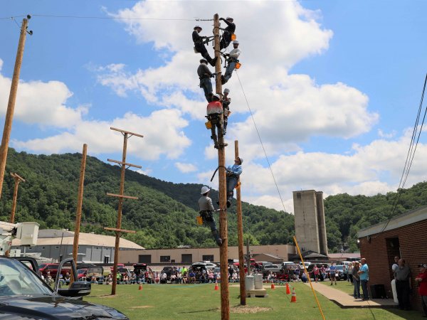 Lineman students on utility pole.